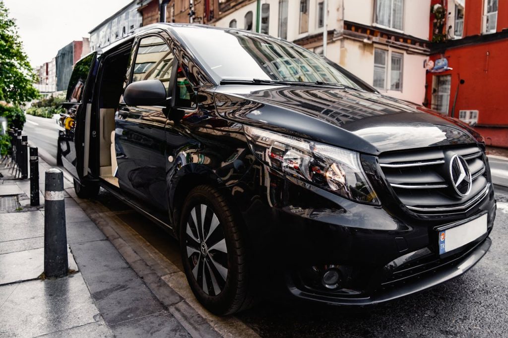 A stylish black Mercedes-Benz van parked on a bustling city street, showcasing luxury and modern design.